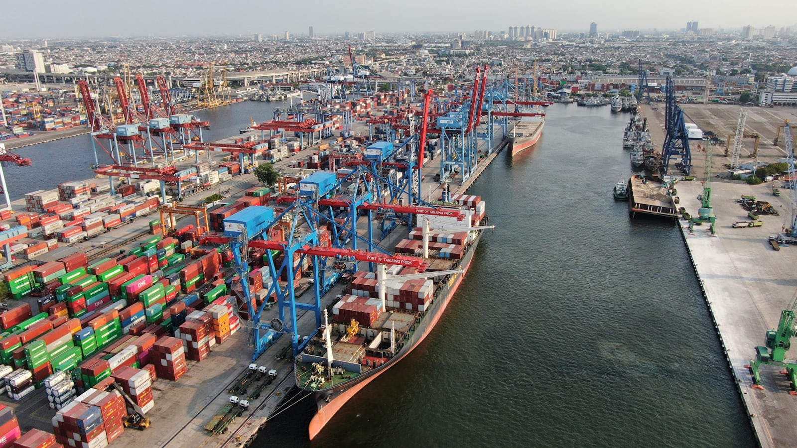Busy container terminal with cranes and stacked containers